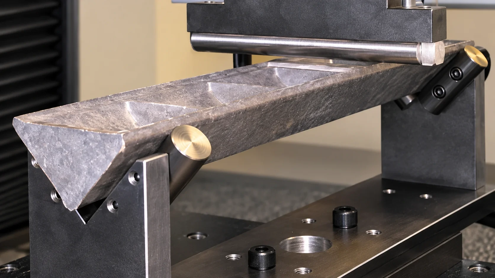 Three-point bending test with specimen and loading fixture.