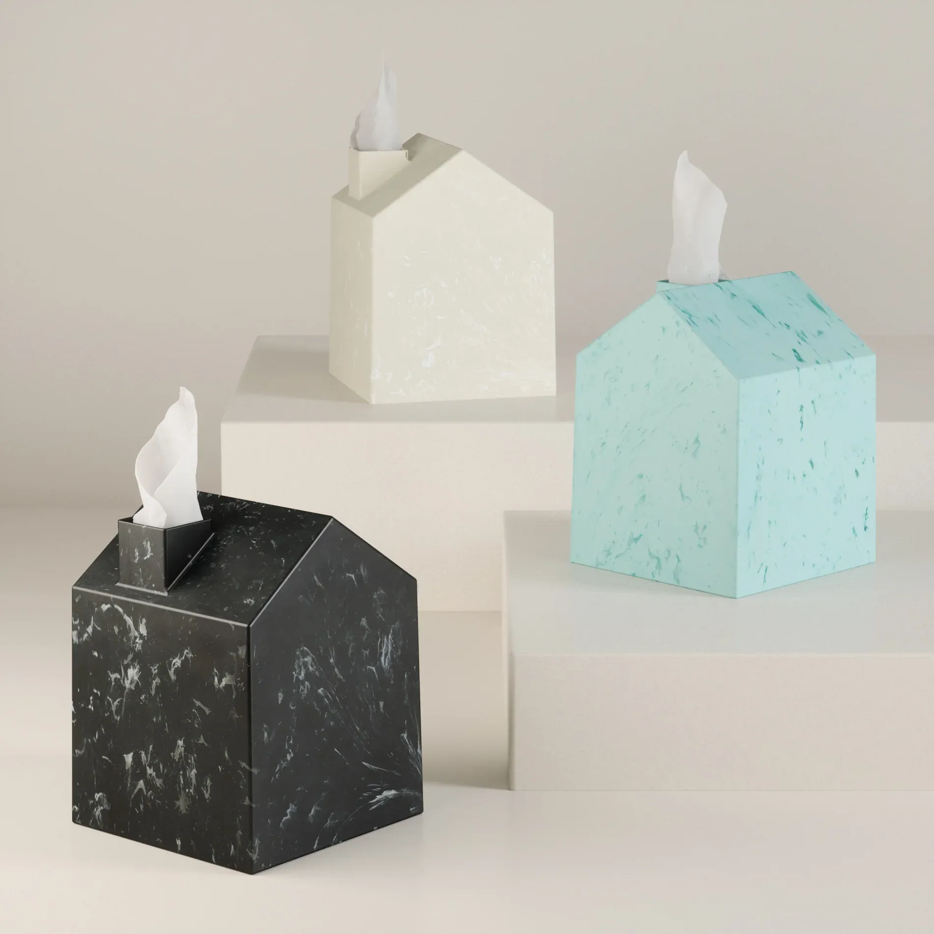 Three house-shaped Umbra Casa Ocean tissue covers in black, cream and aqua, with tissues emerging from their chimneys