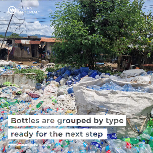 Sorted plastic bottles grouped by type at a collection site in the Philippines, prepared for the next recycling step. Visible text overlay reads: “Bottles are grouped by type – ready for the next step"