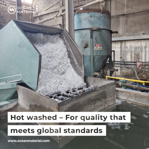 Hot washing process of plastic flakes in an industrial recycling facility to ensure hygiene and meet global quality standards. Text overlay reads: “Hot washed – For quality that meets global standards”.